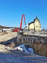 Construction site against clear blue sky