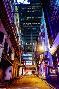 Low angle view of illuminated buildings in city at night