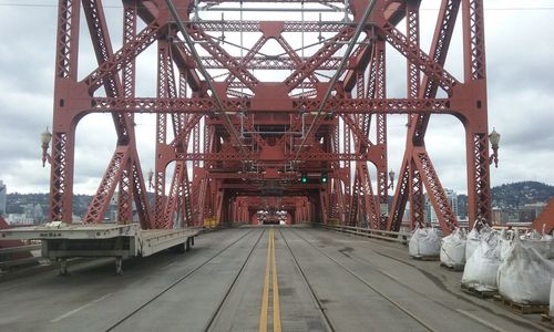 Bridge against cloudy sky