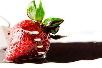 Close-up of strawberry cake against white background