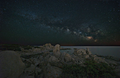 Night landscape at punta molentis sardinia. the milky way over the sea