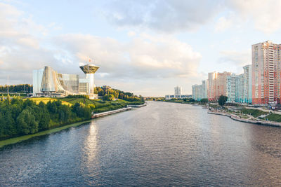 River amidst buildings in city against sky