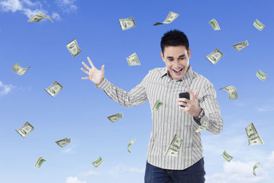 Full length of a man holding smart phone