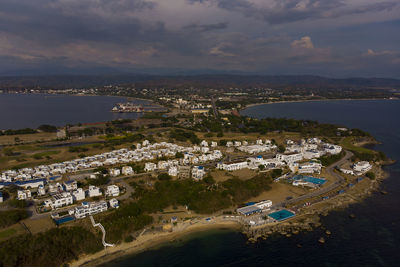 High angle view of buildings by sea against sky