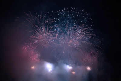 Low angle view of firework display at night