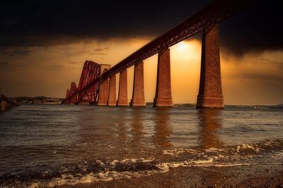 View of bridge over sea during sunset