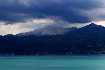 Scenic view of sea and mountains against sky