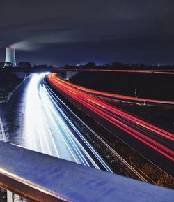 Light trails on road in city at night