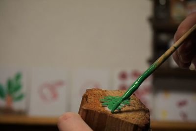 Close-up of hand painting wood