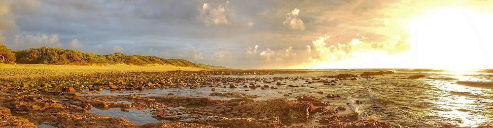 Panoramic view of sea against sky at sunset