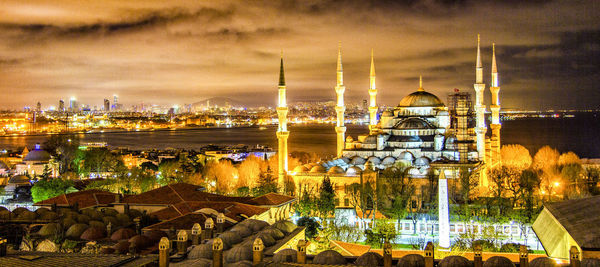 Illuminated buildings in city at night