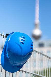 Close-up of coin-operated binoculars against blue sky