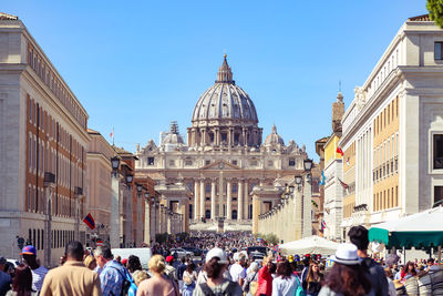 Crowd visiting st peter basilica in city