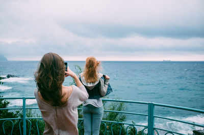 Rear view of woman looking at sea