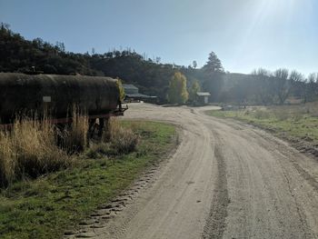 Dirt road along countryside landscape