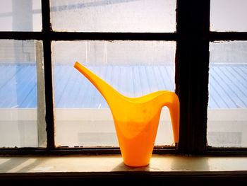 Yellow jar at window sill