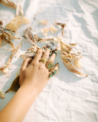 High angle view of woman hand on bed