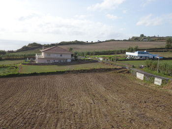 Houses on field against sky