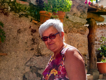 Portrait of smiling senior woman standing outdoors