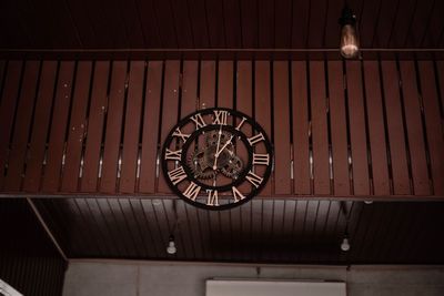 Low angle view of illuminated pendant light hanging on ceiling