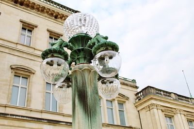 Low angle view of statues on building against sky