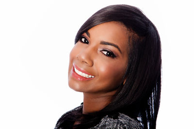 Portrait of smiling young woman against white background