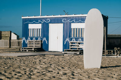 Facade of surf school academy on portuguese beach at sunset with copy space