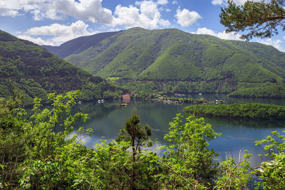 Scenic view of lake and mountains against sky