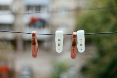 Close-up of clothespins hanging on clothesline