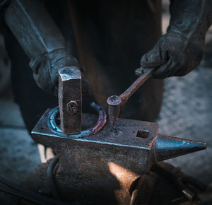 Close-up of man working on metal