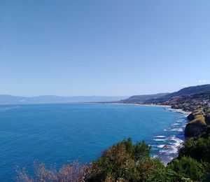 Scenic view of sea against clear blue sky