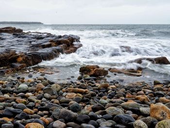 Scenic view of rocks in sea against sky