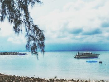 Scenic view of sea against cloudy sky