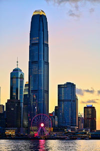 Modern buildings in city at sunset