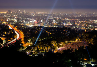 High angle view of illuminated city buildings at night