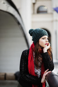 Beautiful young woman standing on the bridge