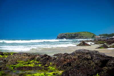 Scenic view of sea against clear blue sky