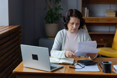 Young woman using laptop at home