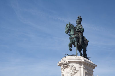 Low angle view of statue against blue sky