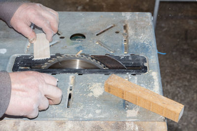 Cropped hand of man working in workshop