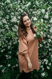 Beautiful girl in blooming apple tree aroma of flowers outdoor nature