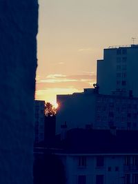 Houses against sky during sunset