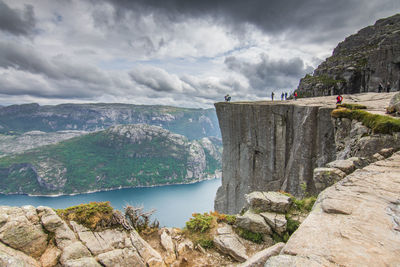 Scenic view of river and mountains against cloudy sky