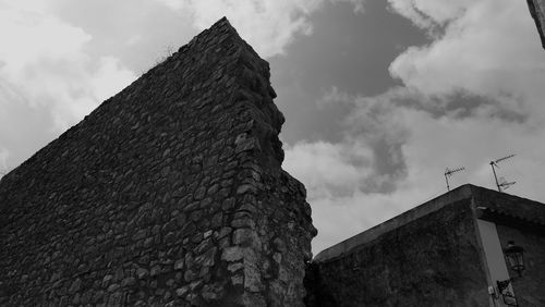 Low angle view of building against cloudy sky