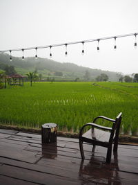 Scenic view of farm against sky during rainy season
