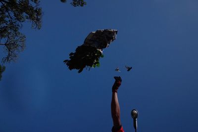 Low angle view of statue against clear blue sky