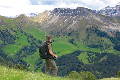 Side view of male hiker standing against mountain at south tyrol