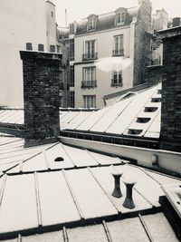 Buildings in city against sky during winter