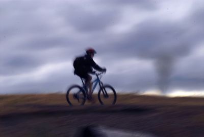 Man riding bicycle on road
