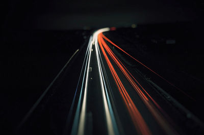 High angle view of light trails on highway at night